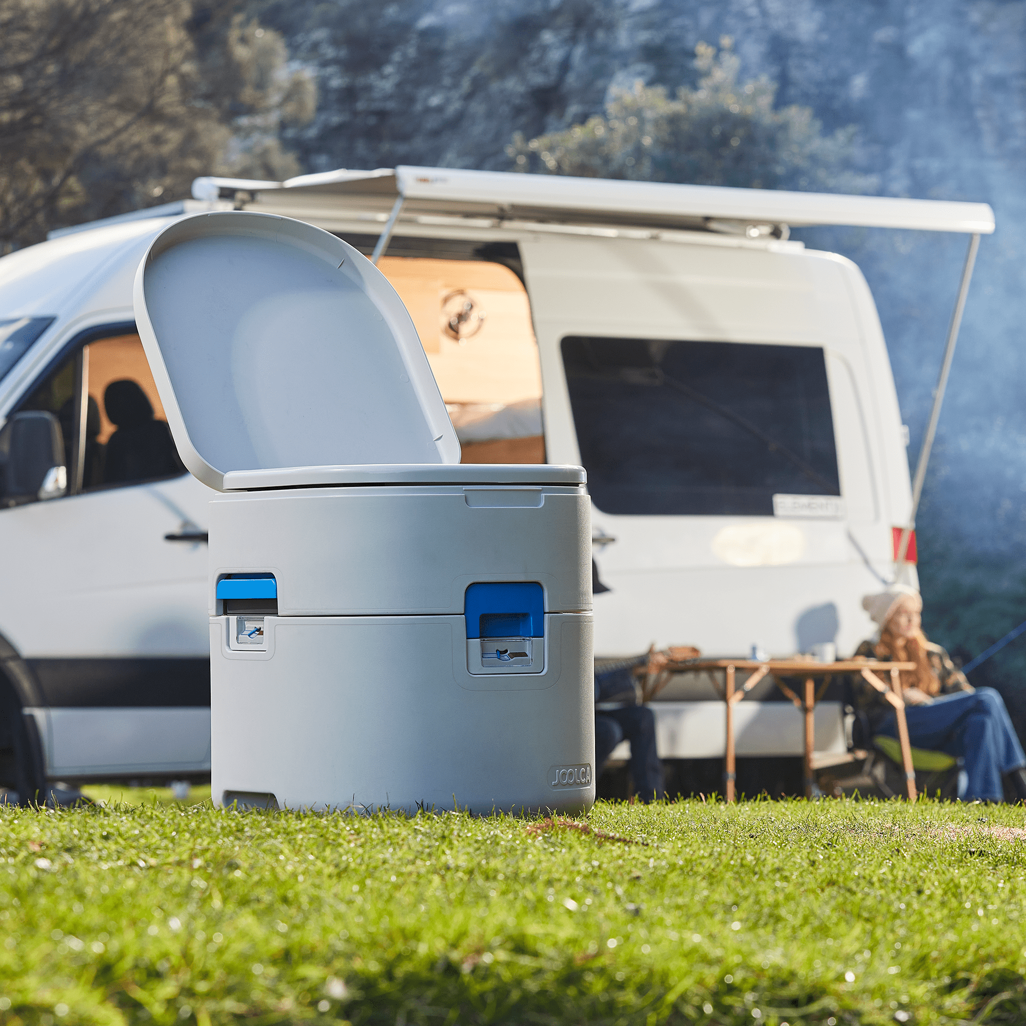 GottaGo with the lid open at a campsite beside a campervan