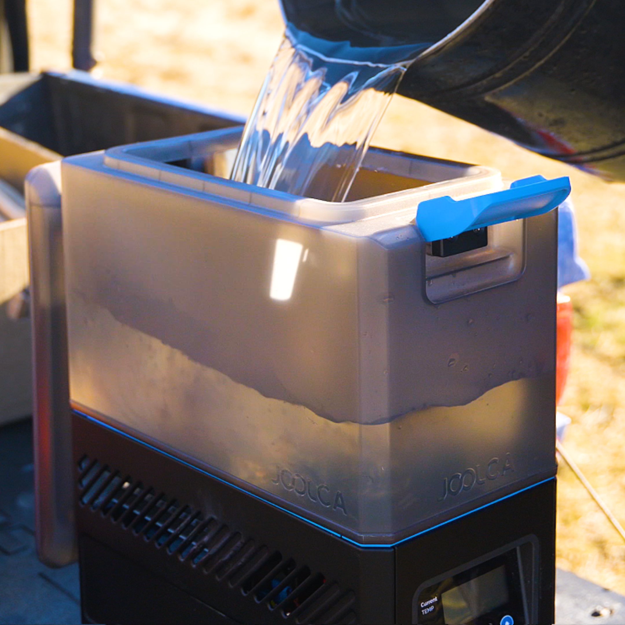 Water being poured into the top reservoir of the HOTTAP Go portable water heater