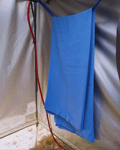Hand reaching into the internal storage pocket of the Joolca Ensuite Mounted Single tent, holding toiletries