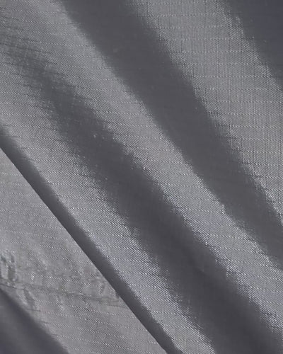 Close-up of a hand zipping up the Joolca Ensuite Mounted Single tent fabric